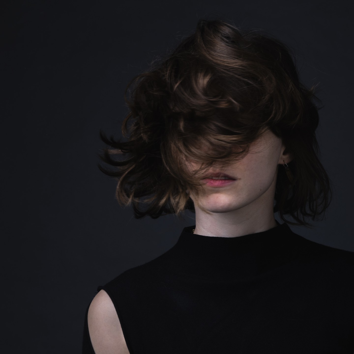 Portrait photograph with hair partly covering the face
